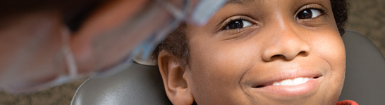 Child in dental chair with dentist